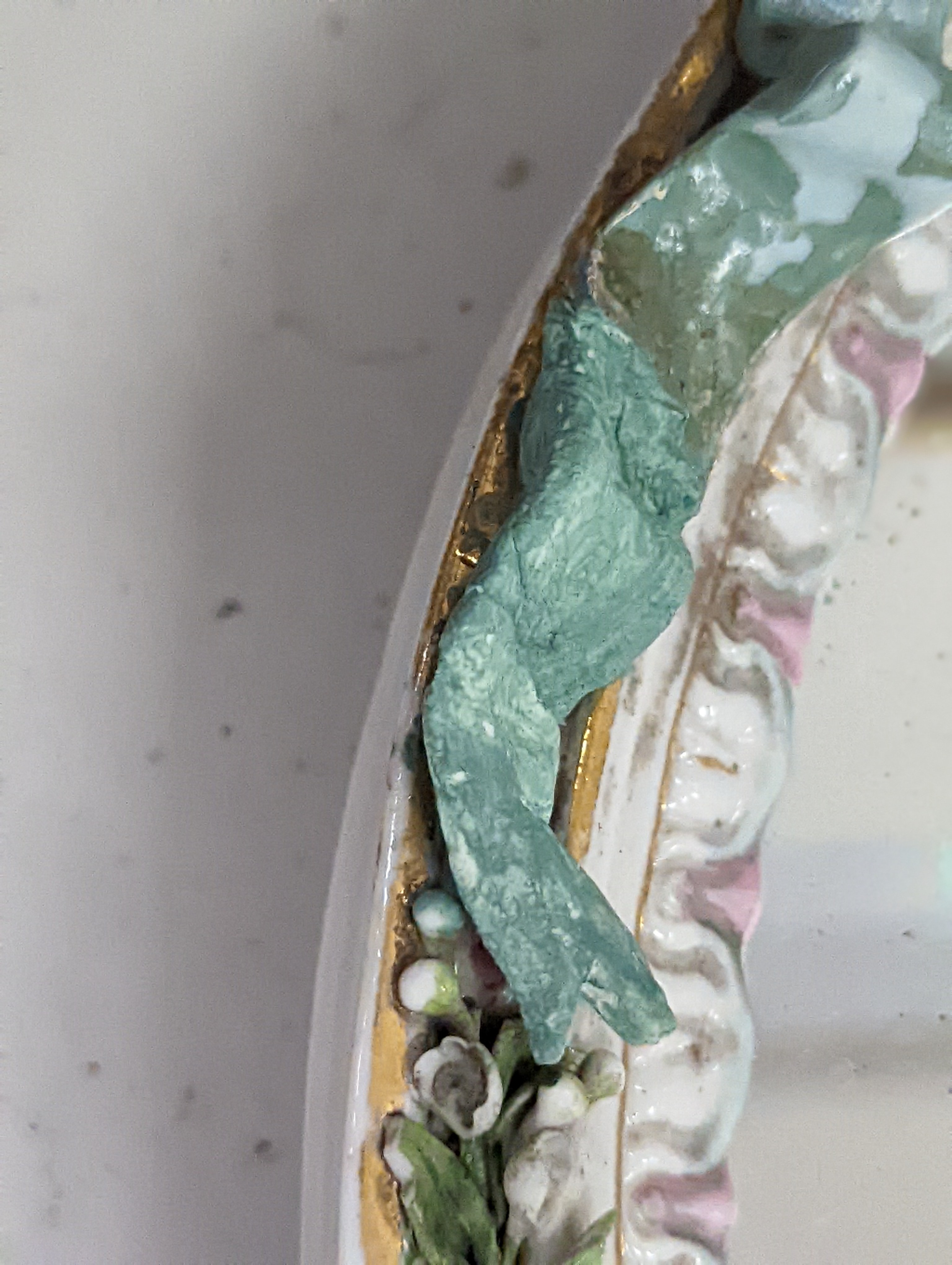 Two German porcelain easel mirrors and a Belleek easel mirror, tallest 43cm